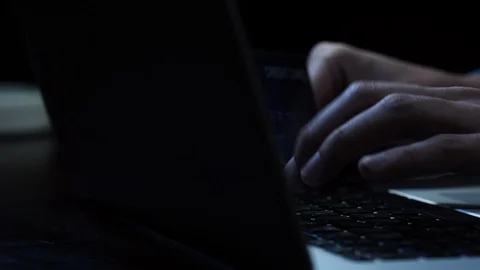 Hands of a man making payment online with credit card at night in dark room Stock Footage 125006152