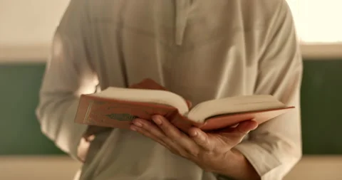 Hands, man in mosque reading Quran and Islamic study of mindfulness, gratitude Stock Footage 249196385