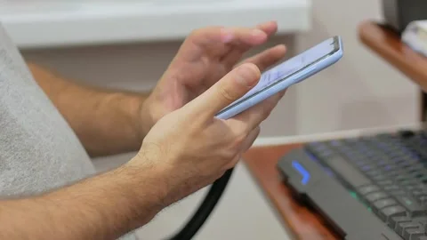 Hands, man, office, home, keyboard, phone, blue, smartphone, cell phone, technol Stock Footage 260164415