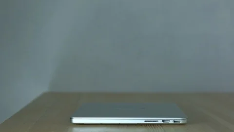 Hands of a man open laptop and browse internet. Close-up. Slowmotion Video stock 102298506