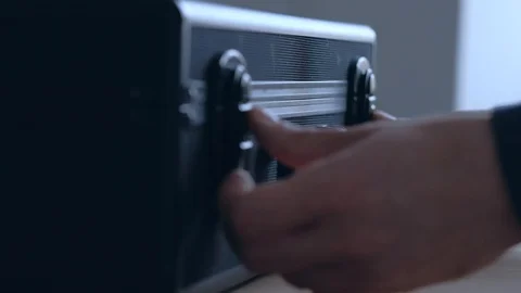 Hands of man opens the lock of black case. Stock Footage 119024942