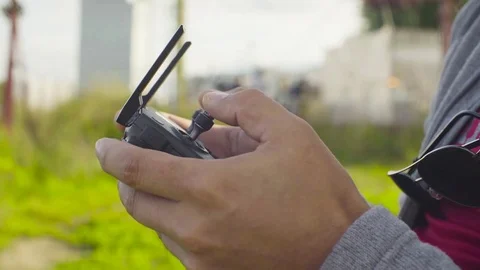 Hands of a man operating a drone quadrocopter Stock Footage 79952550