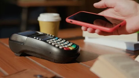 Hands man paying with NFC technology with smart phone credit card application in Stock Footage 115505131