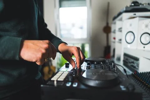 Hands of a man playing on DJ setup at home Stock Photos