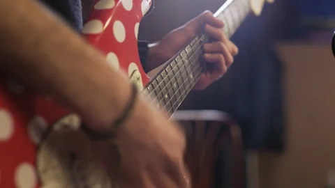 Hands of a Man Playing Red and White Electric Guitar Stock Footage 72156542