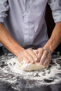 Hands of man preparing bread batter Stock Photos