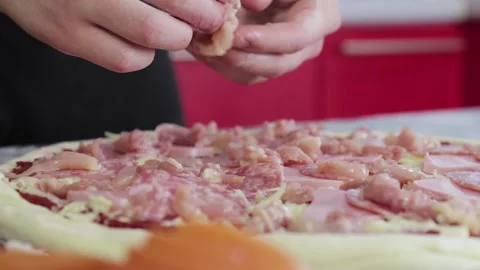 Hands of man put chicken breast on pizza dough close up 動画素材 155835188