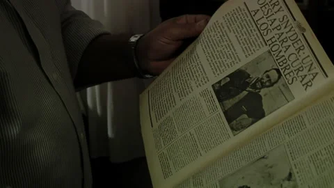 Hands of a Man Reading an Old Article of Gary Snyder in Dark Room at Home.  Stock Footage 243919293