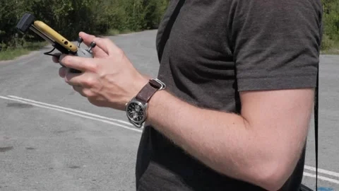 Hands of a man with a remote control from a copter Stock Footage 162108941