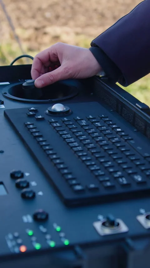 Hands of a man remotely piloting a drone recording video in real time on an Stock Footage 314269619