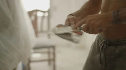 Hands of man removing dried paint from spatula - house reformations Stock Footage 209467911
