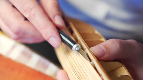Hands of man removing excess glue from plywood details for ship model with Stock Footage 196973041