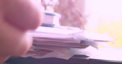 The hands of a man searching for a document in a stack of papers Stock Footage 334945780