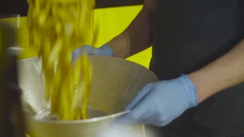 Hands of a man shaking fried potatoes Video stock 77507126