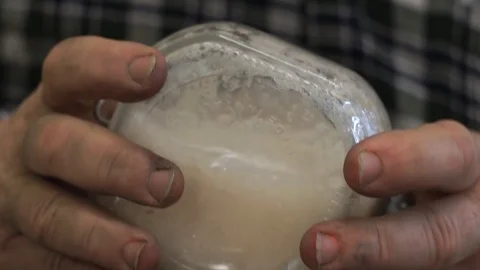 Hands of a man shaking whisking  a liquid Stock Footage 117366228
