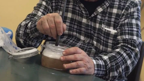 Hands of a man shaking whisking  a liquid, detail Stock Footage 117366359