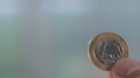 Hands of a man show to camera 1 real brazilian coin Stock Footage 58508982