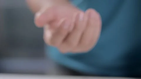 Hands of a man show to camera 1 real brazilian coin Stockbeeldmateriaal 58509621