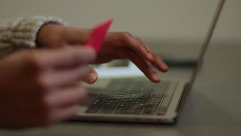 Hands of a man in slow motion enter bank card details into a laptop to pay Stock Footage 264105922