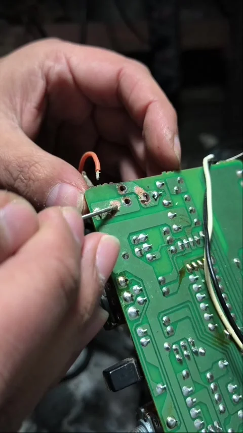 The hands of a man soldering an electronic circuit board Stock Footage 345082371