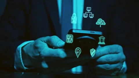 The hands of a man in a suit use a smartphone above which symbols of Stock Footage 278356746