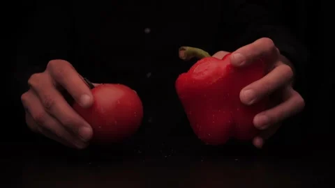 Hands of a man take out vegetables from under the table red tomato and colored Stock-Footage 144370711