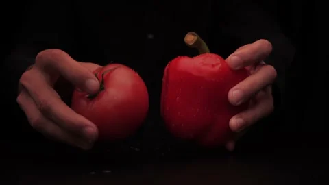 Hands of a man take out vegetables from under the table red tomato and colored Stock Footage 144370732