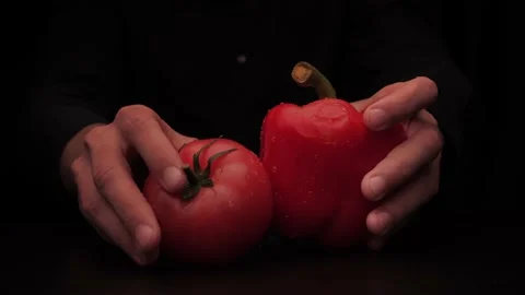 Hands of a man take out vegetables from under the table red tomato and colored Stock-Footage 144370793