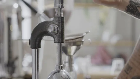 Hands of a man with a tattoo get a squeezed lemon from the press. The process of Stock Footage 129638694