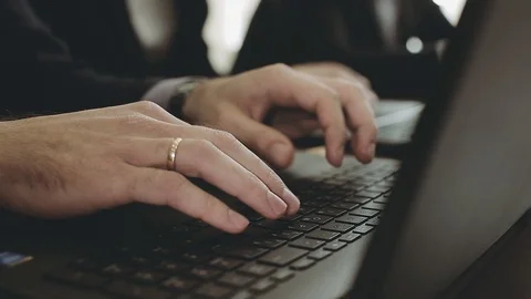 Hands of a man typing on a computer keyboard. A business meeting. Video stock 89668274