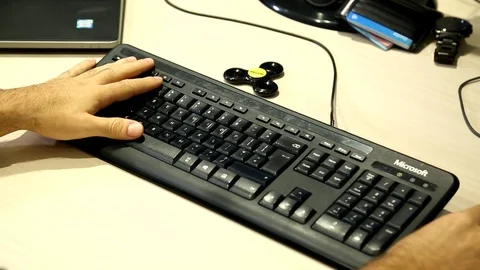 Hands Of A Man Typing On A Computer Keyboard Video stock 99540751