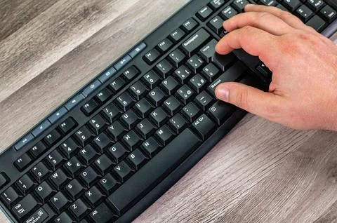 Hands of a man typing on the pc keyboard Stock Photos
