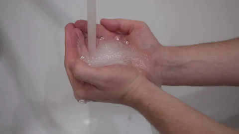 Hands of a man under a tap with running clean water, boiling water Stock Footage 155058564