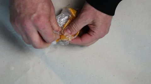 The hands of a man unpack a parcel from an online store. 動画素材 169785936