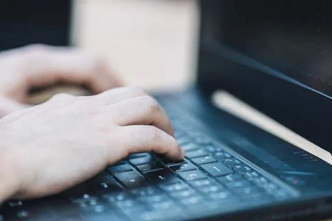 Hands of a man using a keyboard to trade in cryptocurrency Stock Photos