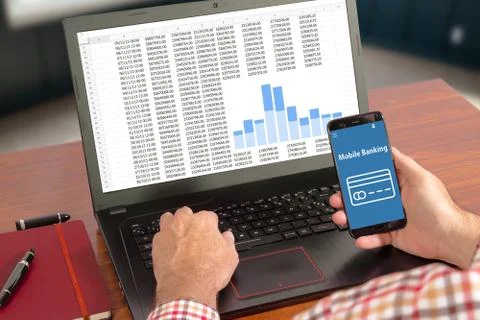 Hands of a man using a laptop an a mobile phone with blank screen Stock Photos