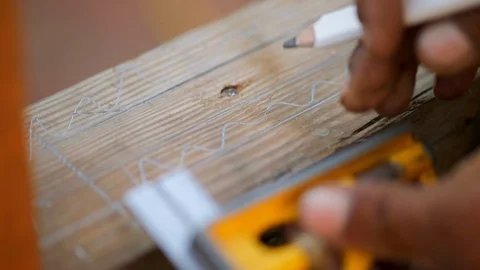 Hands of man using a ruler to make measurements on a piece of wood Stock Footage 88367878