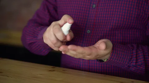Hands of man using sanitizer spray to clean up his hands and kill corona virus Stock Footage 128316497