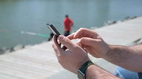 Hands of man using smartphone in the street. Close-up view of male hands holding Stock Footage 253806975