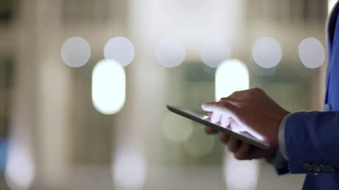 Hands of man using tablet computer while walking Stock Footage 100689910