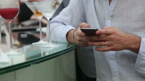 Hands of man is usinging cellphone in club Stock Footage 62523440