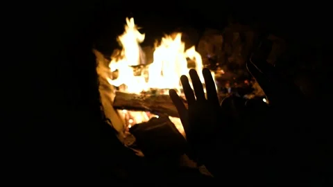 Hands of man warming up by camp fire. Body parts of adult male at nature. Stock Footage 152800579