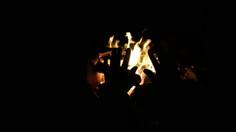 Hands of man warming up by camp fire. Body parts of adult male at nature. Stock Footage 155872143