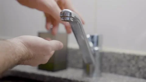 Hands of man wash their hands in a sink with foam to wash the skin and water Stock Footage 164017430