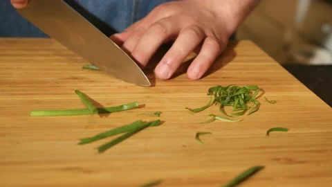 Hands of a man who cuts green onions Stock Footage 198967412