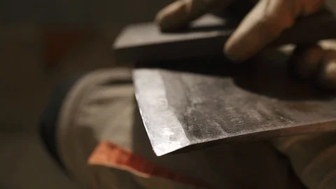 Hands of a man who is sharpening an ax blade Stock Footage 116767601