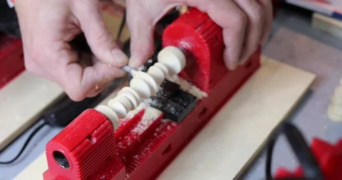 Hands of man working on small turning machine on table in workshop Stock Footage 276362708