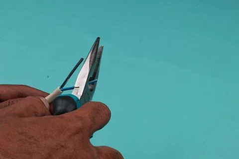 Hands of a man working with wires. Stock Photos