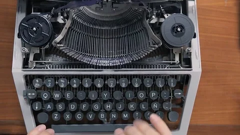 The hands of a man writing on an old typewriter. Top view Stock Footage 73763459