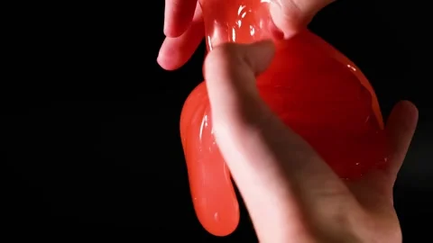 Hands Manipulating Bright Red Slime Close-Up Stock Footage 309744298